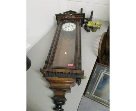 An early 20th century walnut and ebonized Vienna style wall clock, with enamelled Roman dial with subsidiary dial below 12 an