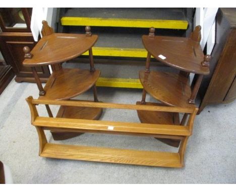 A pair of Ercol three tier what-nots, together with a light Ercol wall hanging shelf 