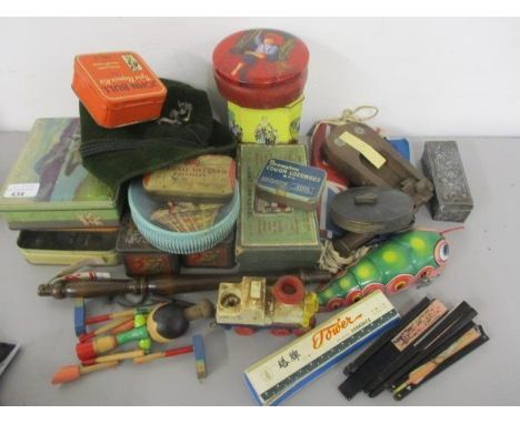 A mixed lot to include tins, Harmonica, fans and other items 