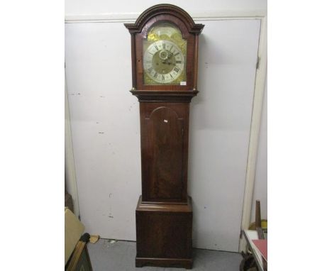 A George III mahogany 8 day longcase clock. The brass dial having a mottled centre, silvered chapter ring, subsidiary seconds