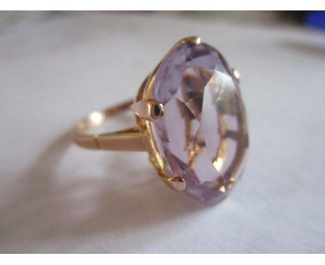 A 9ct gold ring with a large oval amethyst stone 