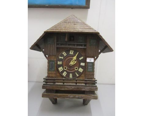 A 19th century Black Forest cuckoo wall clock, modelled as a house having bone numerals and hands and an 8 day fusee movement