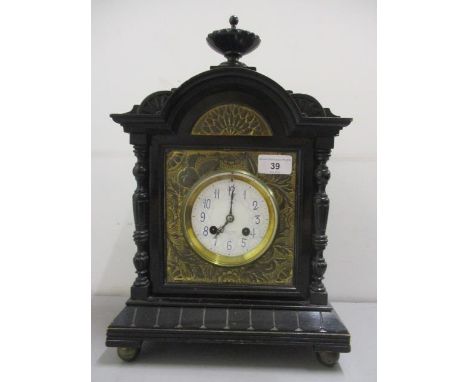 A late 19th century black lacquered mantle clock having a white enamelled dial with blue Arabic numerals and inscribed J W Be