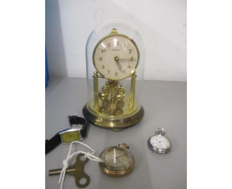 A small anniversary clock, a chrome cased wristwatch, a silver cased fob watch and a gold plated cased pocket watch 