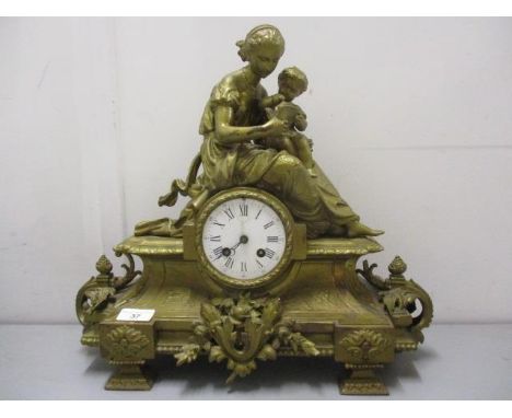 A late 19th century French gilt metal mantle clock, the case modelled as a classical lady and child with foliate decoration. 