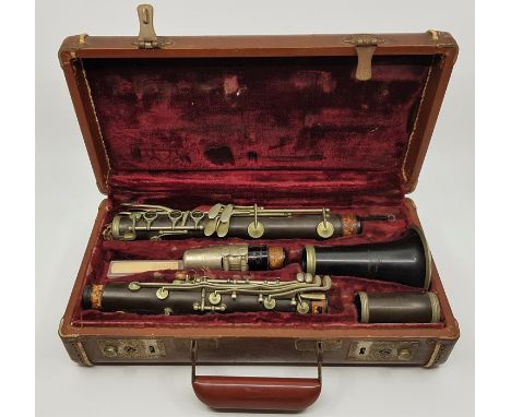 A c.1940's (or earlier) C.G. Conn clarinet, together with a Selmer Goldentone mouth piece, in case.