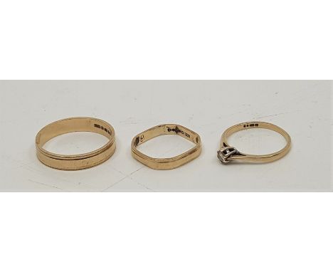 A 9ct. gold band, with engine turned edges, together with another 9ct. gold band, of octagonal form, and a&nbsp;9ct. gold sol