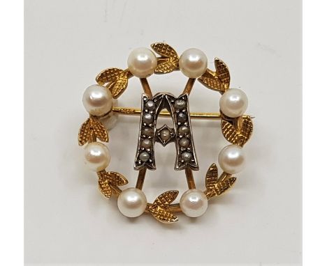 A 9ct. gold and cultured pearl wreath brooch, with stylised initial 'A' to centre set seed pearls, diameter 25mm. (gross weig