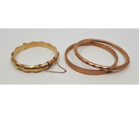 A 9ct. gold simulated bamboo hinged bangle, assayed Birmingham 1961, of slightly ovoid form, external measurement 70mm x 65mm