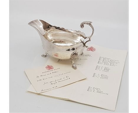 A silver sauce boat, by Harrison Brothers &amp; Howson, assayed Sheffield 1930, with flying scroll handle, raised upon triple