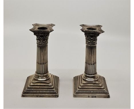 A pair of Victorian silver Corinthian column candlesticks, by William Hutton &amp; sons Ltd, assayed London 1899, weighted to