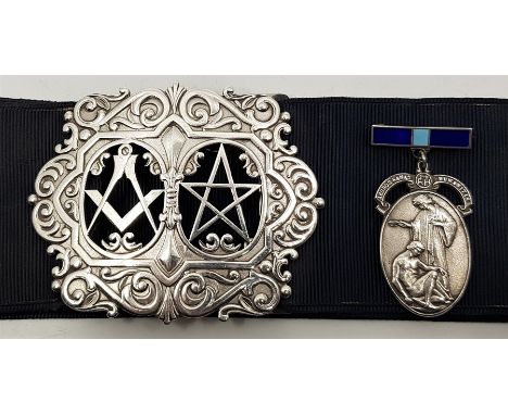 A silver Masonic nurses buckle, by Toye, Kenning & Spencer, assayed Birmingham 1978, pierced with square and compass and pent