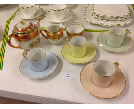 A Noritake orange lustre teapot, sugar bowl and milk jug with 4 Noritake pastee coloured coffee cans