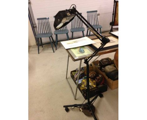 A floor standing angle poise lamp with magnifier.