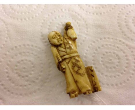 An unsigned netsuke of a man holding a gourd aloft.