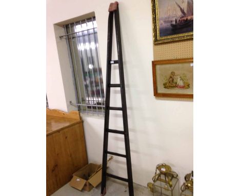 Vintage tapered window cleaners ladder with hickory wood rungs.