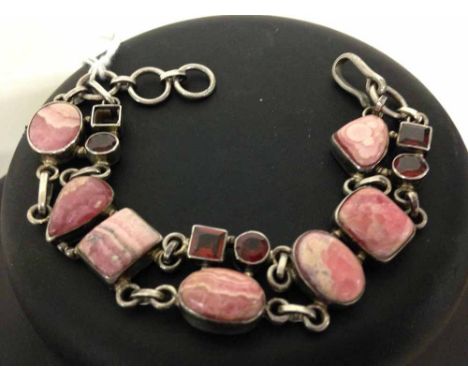 925 silver bracelet set with polished & cut Rhodochrosite stones. One small stone missing.