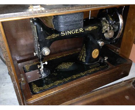 A cased vintage singer sewing machine