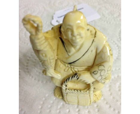 A signed netsuke of a fisherman.