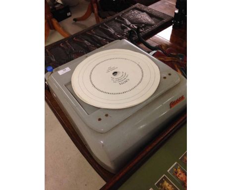 A c1950s Gross cash register with unused paper recorder discs.