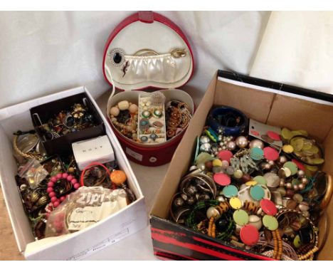 A large quantity of modern & vintage costume jewellery to include a red heart shaped travelling jewellery box.