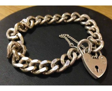 A heavy silver ladies link bracelet with heart padlock & safety chain. Approx weight 31g.