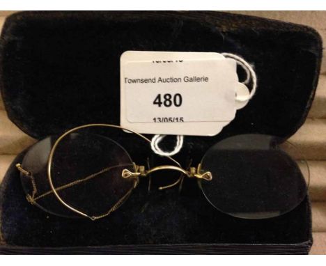 A pair of vintage gold spectacles with ear clip - cased.
