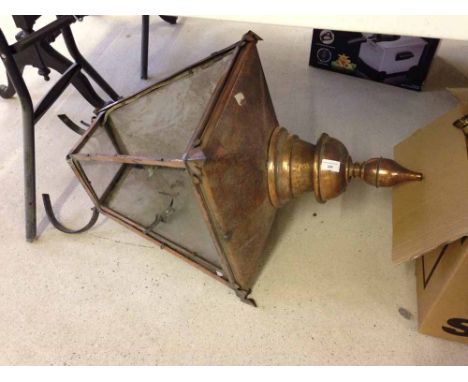 A vintage copper street lantern in need of replacement glass.