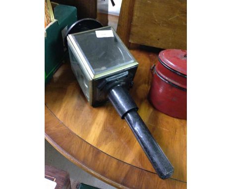 A vintage carriage/coach lamp with red glass windw to side.