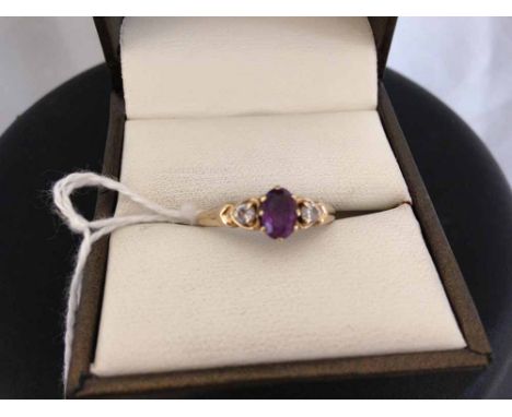 9ct gold ladies ring set with central amethyst with white Cubic zirconia's either side. Size N.