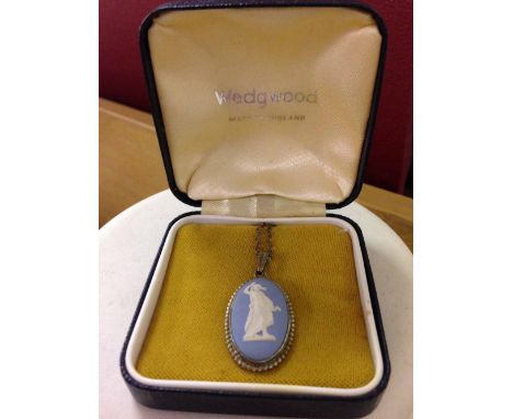 A boxed Wedgwood blue jasperware pendant in a silver oval mount on a silver chain. 16 Inch.