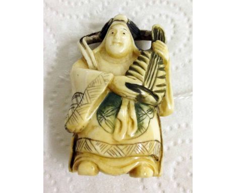 A signed netsuke of a mandolin player.