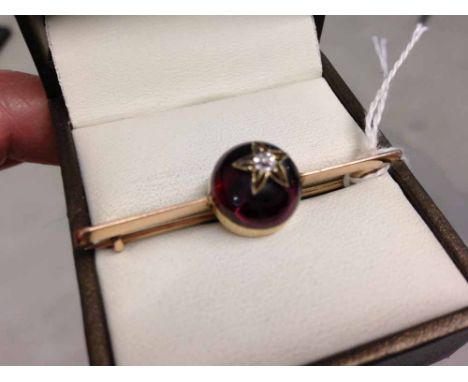 Vintage gold bar brooch with large red cabouchon decorated with a star and central diamond - tests as 14ct gold.