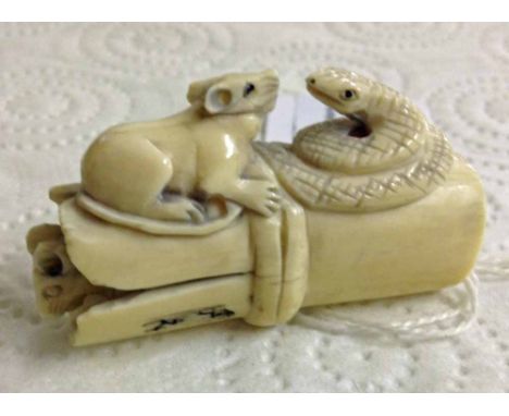 A signed netsuke of rats and snake on bamboo.