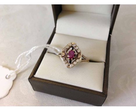 9ct gold ring set with oval ruby with a diamond shaped mount set with small white stones. Weight approx 3.4g size V