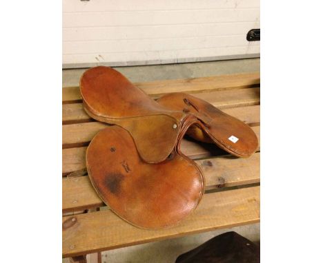 A light brown leather jockey's racing saddle.