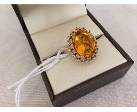 Gold plated 925 silver dress ring with large orange stone surrounded by diamante, size R.