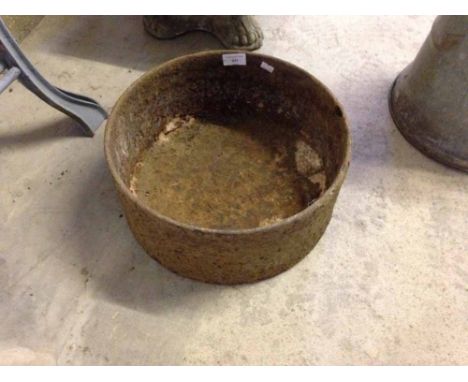 A vintage cast iron pig feeding trough.