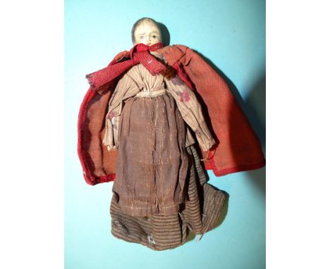 A 19th century Grodner Tal-type peg doll with painted hair, features and lower limbs with red/pink shoes, (one lower arm miss