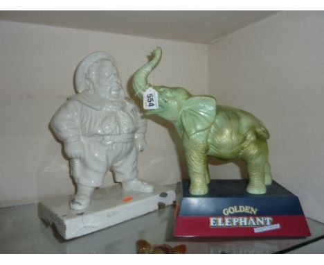 A 'GOLDEN ELEPHANT' ADVERTISING SIGN and an early ceramic Naval figure, missing cigarette (sd) 