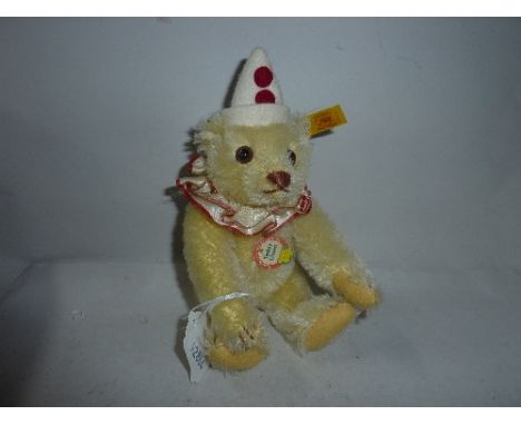 A MINIATURE STEIFF 'TEDDY CLOWN', yellow, length approximately 18cm