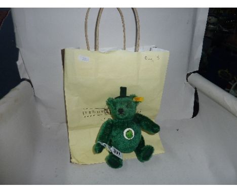 A MINIATURE STEIFF 'FRUITIES' TEDDY BEAR, green, length approximately 18cm, with a bag