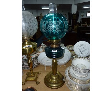 A BRASS OIL LAMP, blue glass well and shade  