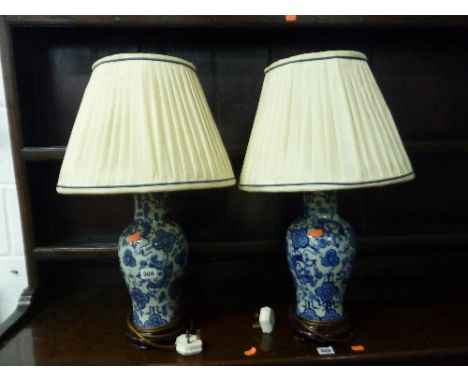 A PAIR OF BLUE AND WHITE CERAMIC TABLE LAMPS, with shades