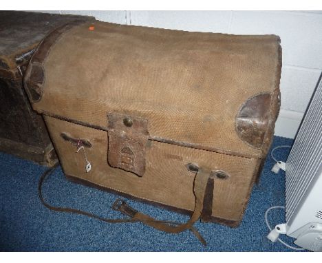 A CANVAS AND LEATHER BOUND DOME TOP TRUNK