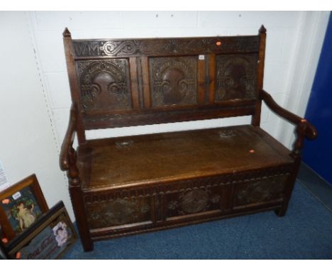 A GEORGIAN CARVED OAK TRIPLE PANEL HALL SETTLE, the top rail inscribed W M 1710