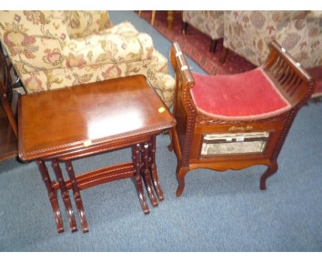 AN EDWARDIAN WALNUT PIANO STOOL, with glazed fall front and a nest of three mahogany tables (2)