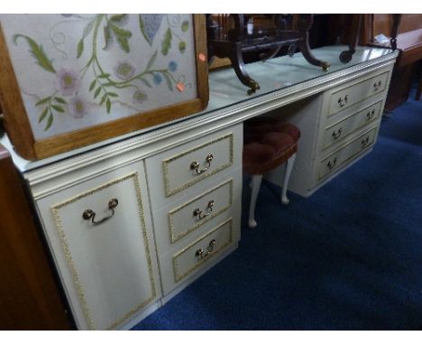 A LARGE CREAM AND GILT DRESSING TABLE, a similar separate triple mirror and a stool (3)