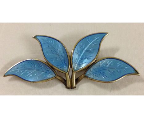 An enamelled silver David Andersen brooch with 4 leaves in blue enamelling. Approx 6.5 x 2.5cm. Enamel in perfect condition.
