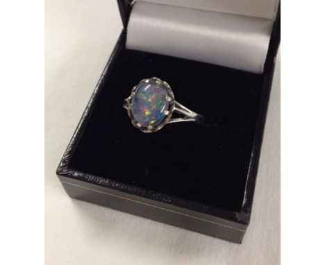 A hallmarked silver ring set with an oval opal cabouchon stone. Size approx S1/2